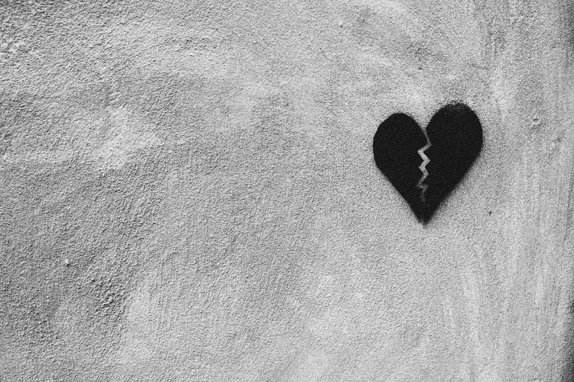 Broken black heart symbolizing emotional pain and cruelty