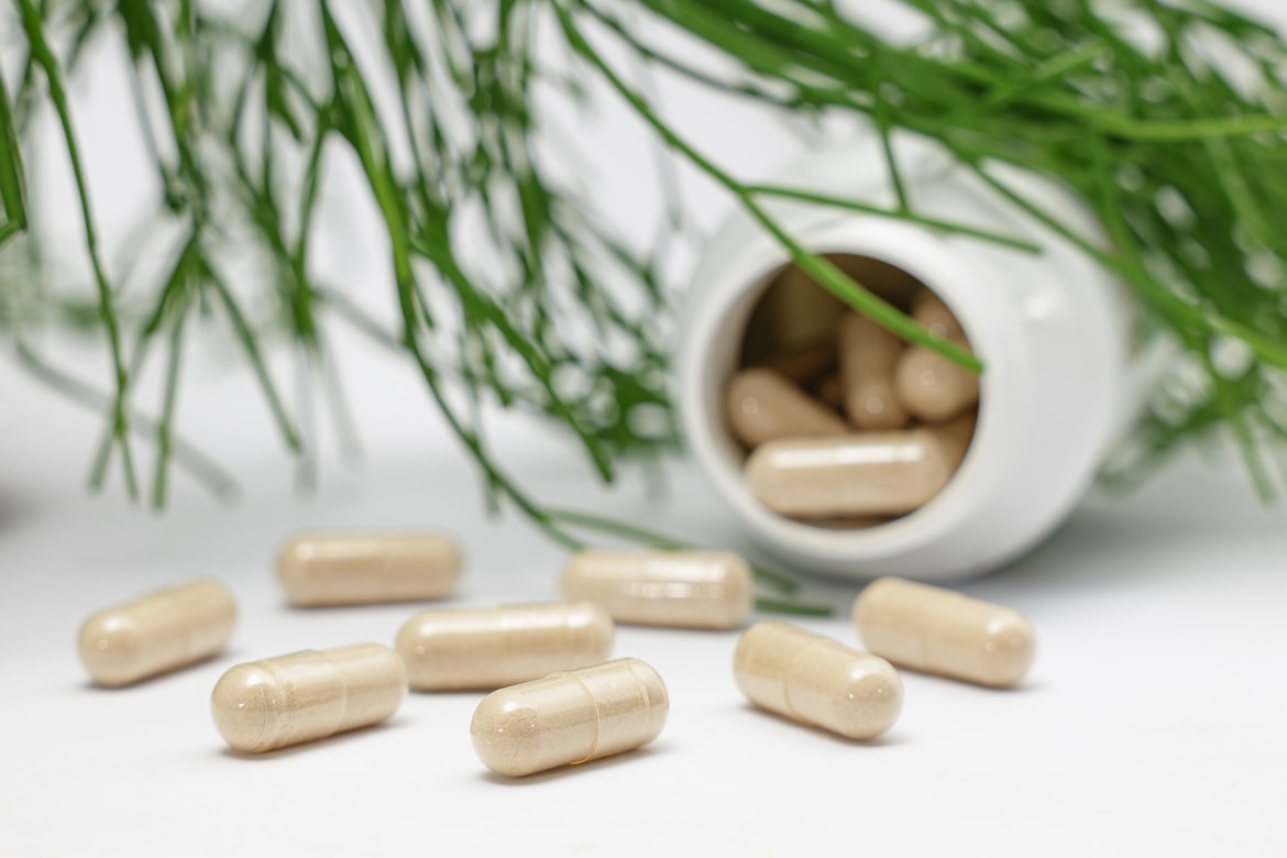 Comparison of prescription medication bottles and natural supplement bottles arranged side by side